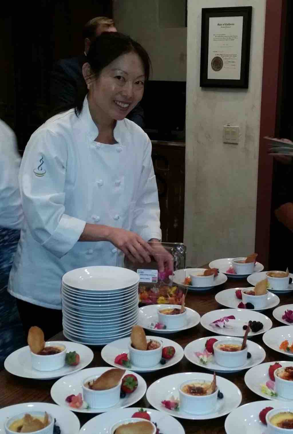 Chef Cynthia Liu preparing plates of food at event