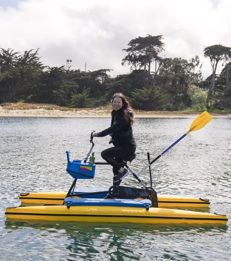 Cynthia Liu riding a hydrobike on calm water